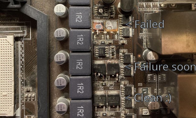 Half-scrapped transistors on a motherboard showing my poor unsoldering skills